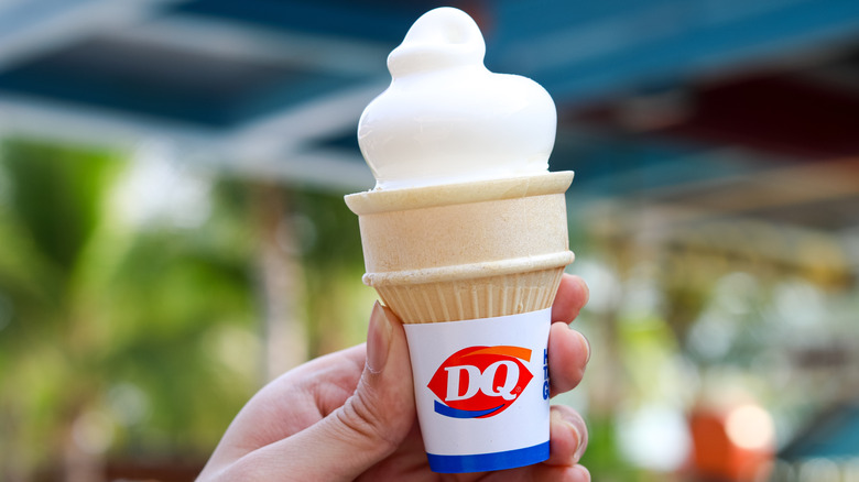 Hand holding Dairy Queen vanilla ice cream cone