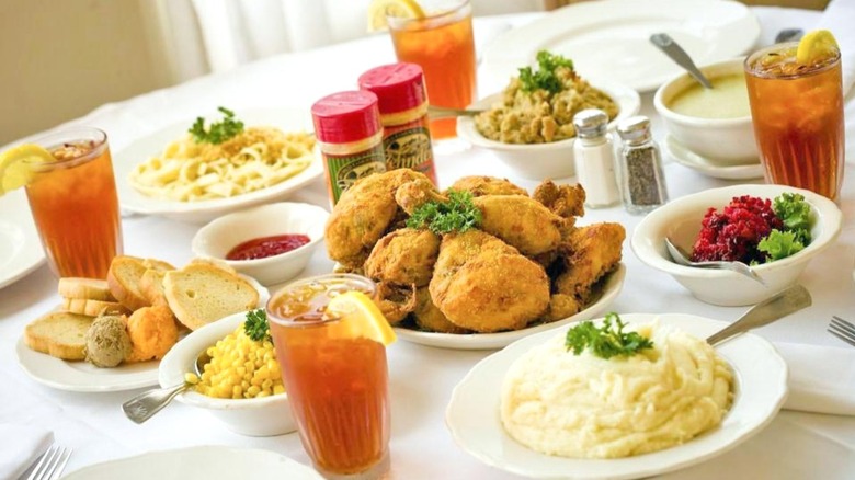 A table spread of fried chicken, mashed potatoes, corn, and drinks at Zehnder's Restaurant