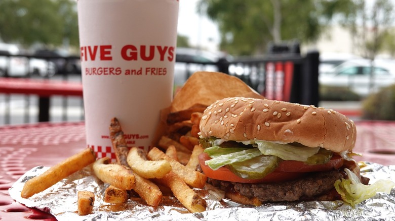A meal from Five Guys on an outdoor table.