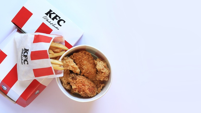A bucket of KFC and fries, viewed from above.