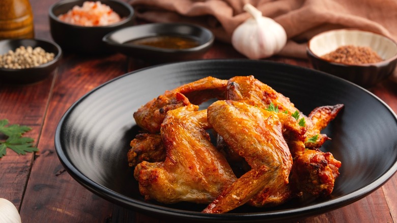 Whole air fryer chicken wings on a plate.