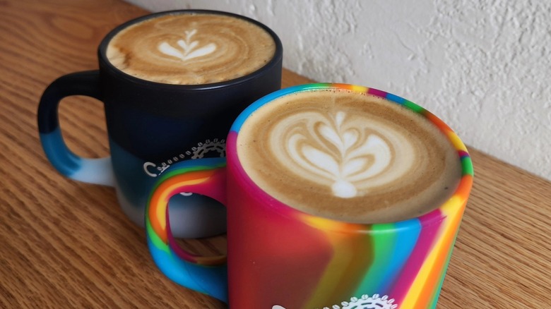 Two coffee mugs with latte art from Coffee Cycle Roasting