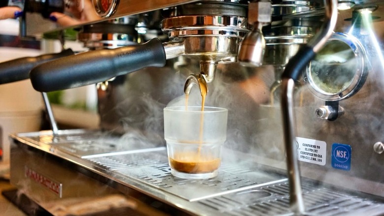 Espresso machine mid espresso pour with steam coming out of machine at Revelstoke Coffee