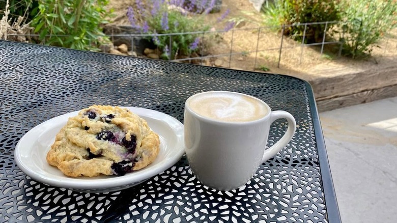Latte and baked scone on table on outdoor patio at River Rock Roasting Company