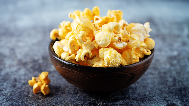 Cheese-flavored popcorn in a black bowl