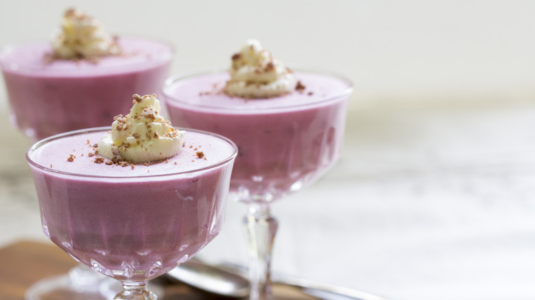 glasses of boysenberry flummery with whipped cream and grated chocolate