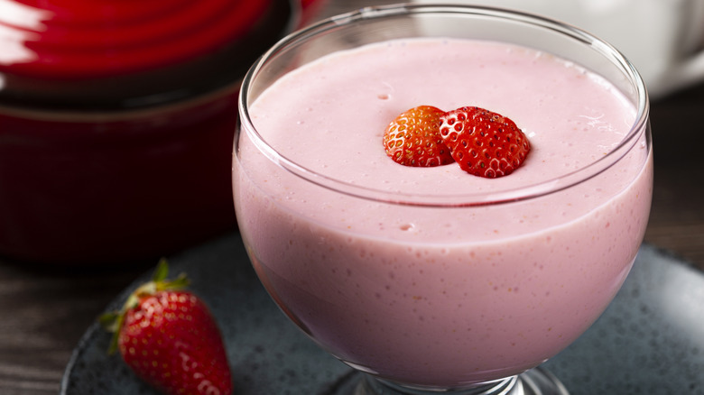 glass of strawberry flummery garnished with fresh strawberries