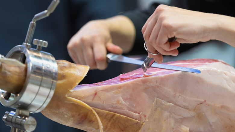 Man cutting jamon iberico