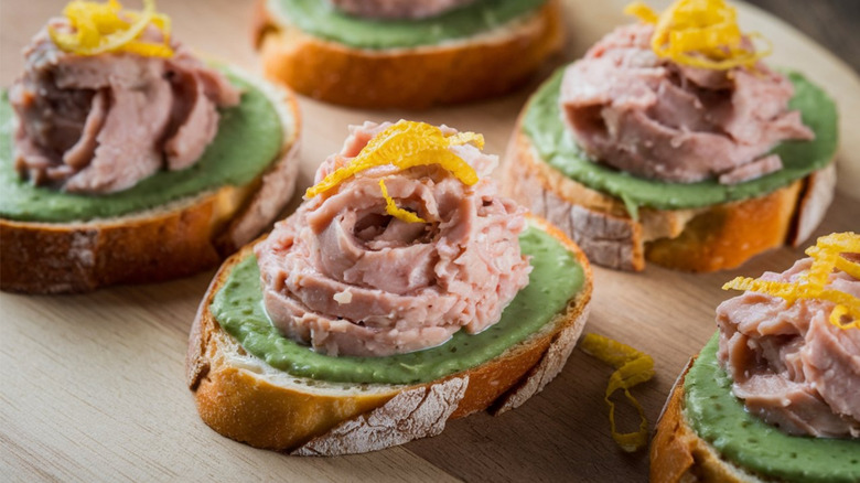 Baccala mantecato served on bread with orange zest on top