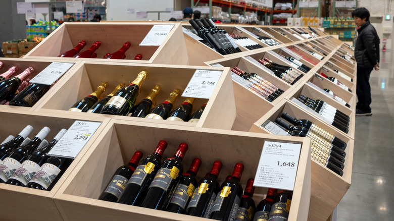 A customer browses the wine section at Costco