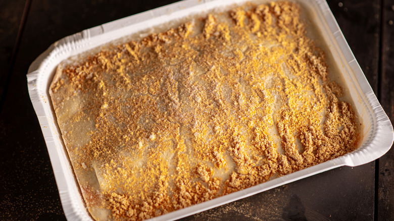 A frozen lasagna in a foil pan