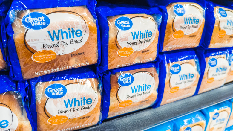 A shelf stocked with Great Value White Bread