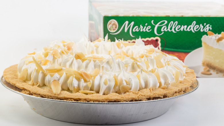 Marie Callender's pie with whipped cream on top of it and Marie Callender's box in the background
