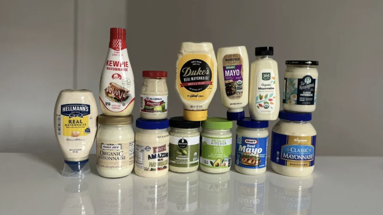 Lineup of store-bought mayo on kitchen countertop.