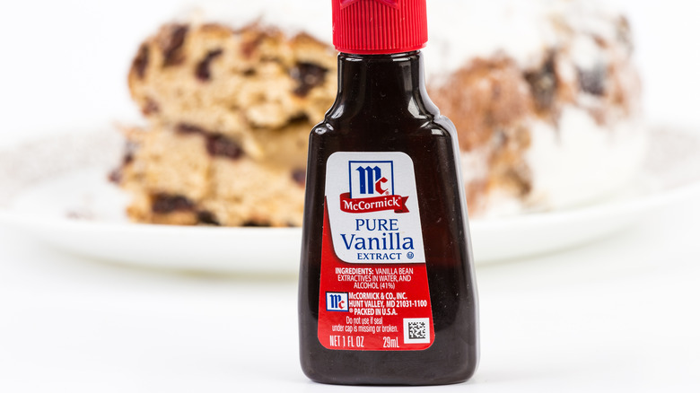 A bottle of McCormick pure vanilla extract in front of a plate of scones
