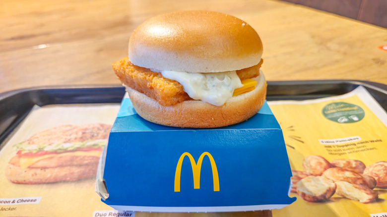 A McDonald's Filet-O-Fish sandwich sits on a box on a tray