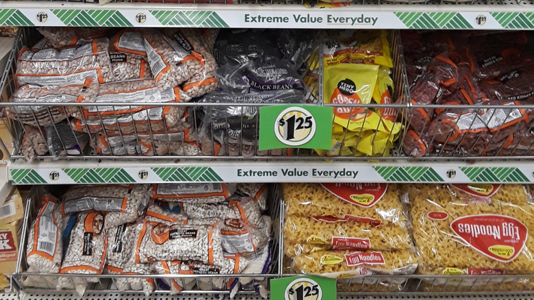 The dried bean section in a dollar store, labeled with a $1.25 sign