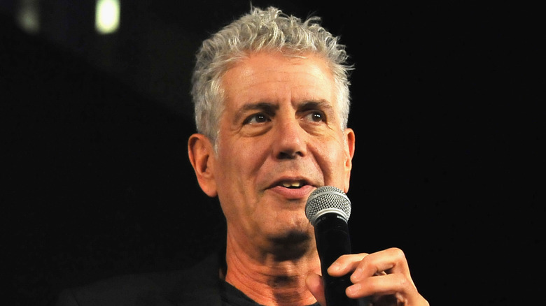 Anthony Bourdain speaking into microphone