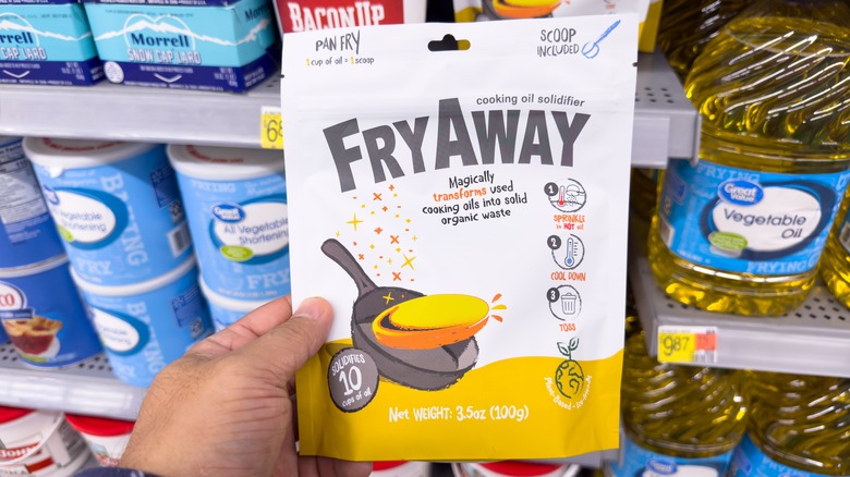 A hand holding a bag of FryAway.