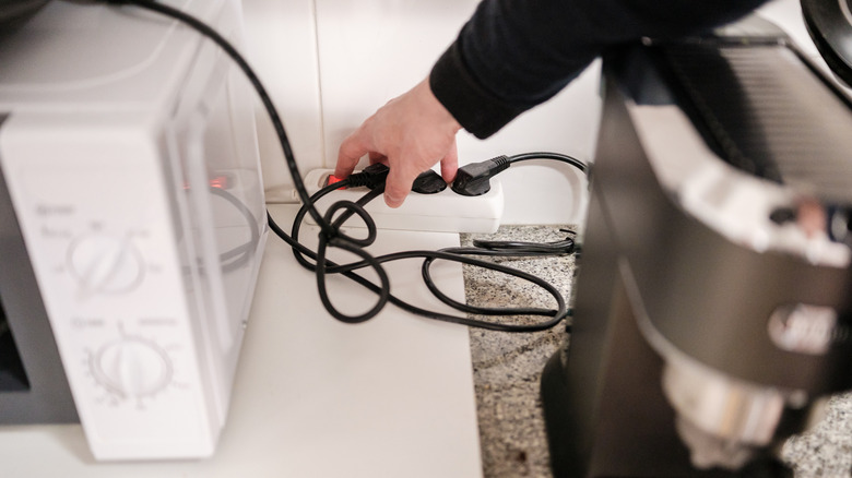 Cord for a microwave being plugged into a power strip