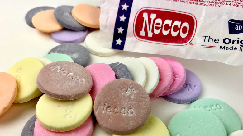 Assorted Necco wafers and their paper sleeve