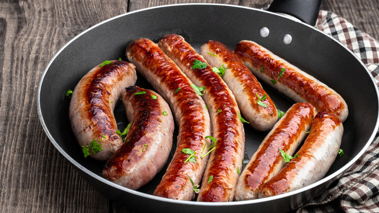Group of sausages stuffed into pan