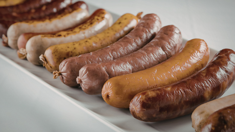 Variety of cooked sausages in a row