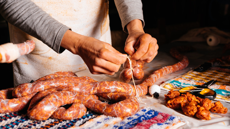 Woman making sausages from scratch
