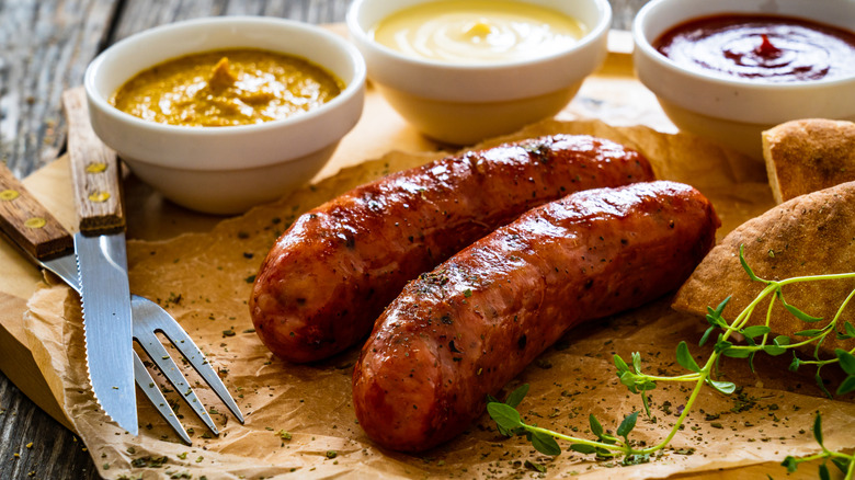 Sausages resting on a board before being cut or eaten