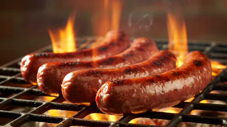Sausages grilling over fire