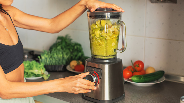 Woman using a blender