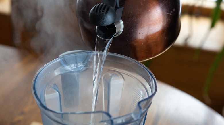 Hot water being poured into a blender
