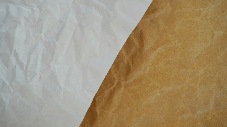 Crumpled white and brown paper, smoothed out and placed beside each other.