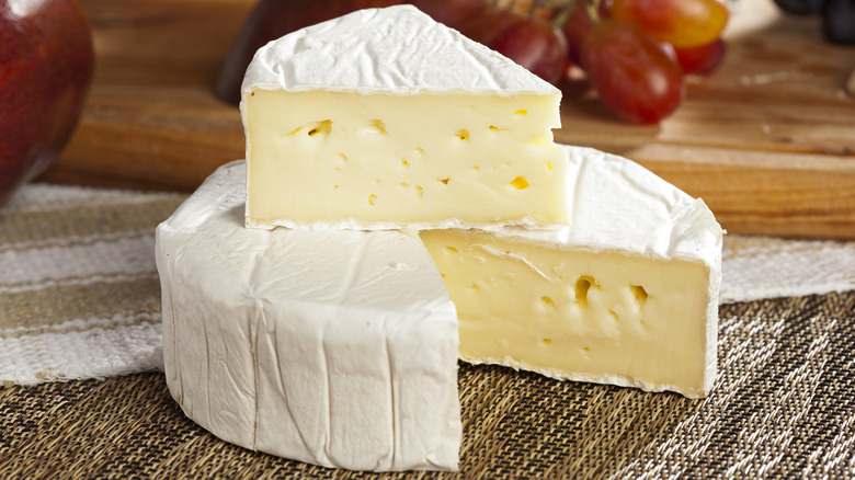 A wheel of brie cheese with a wedge cut out