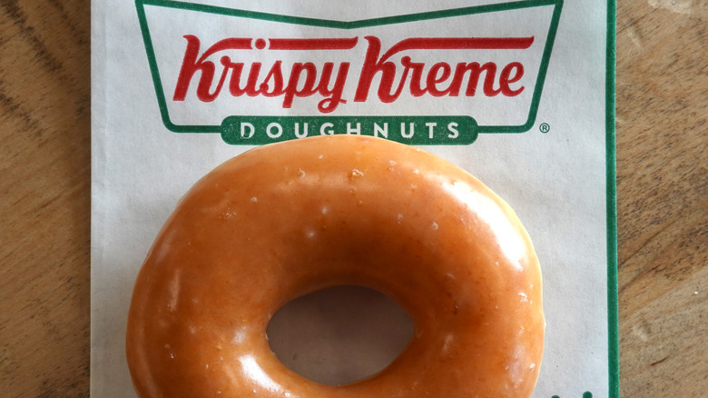Krispy Kreme glazed doughnut on bag