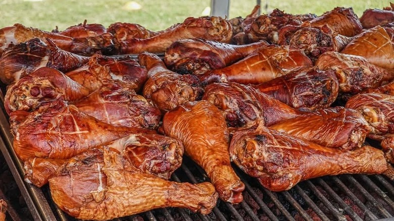 An open grill covered with smoked turkey legs at the Georgia State Fair.
