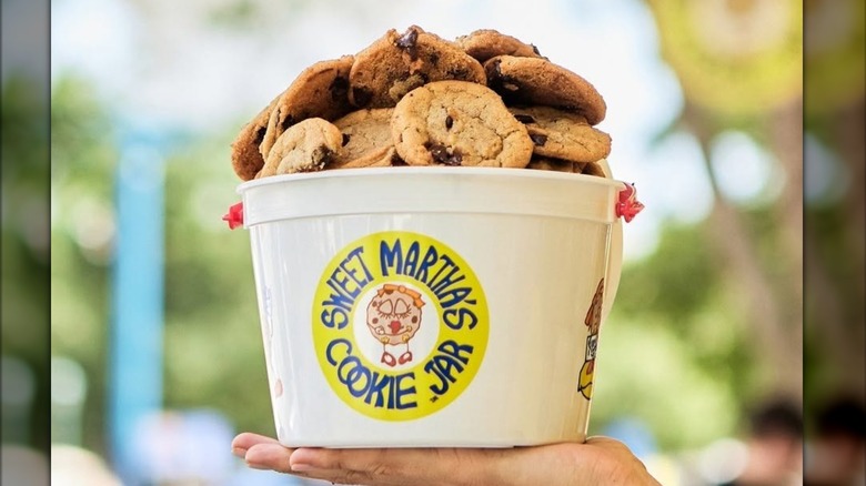 A Sweet Martha's Cookie Jar bucket overflowing with chocolate chip cookies.