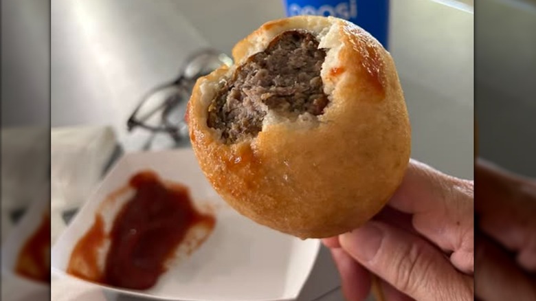A Viking, a battered and deep-fried Norwegian meatball on a stick, with ketchup for dipping.
