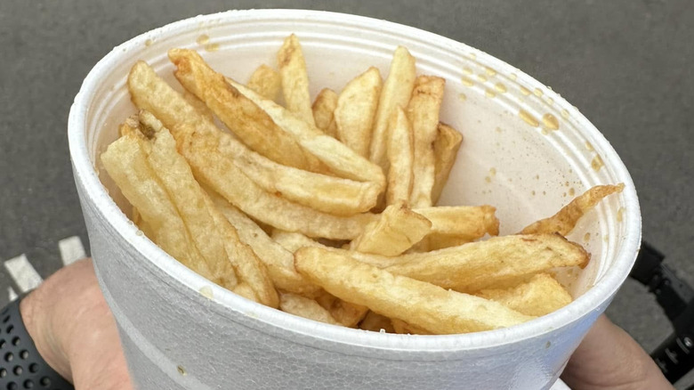 Top view of a styrofoam cup full of Fiske Fries with drops of malt vinegar at the South Caroling State Fair.