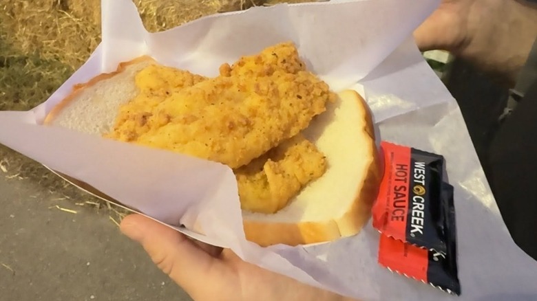 VSU fried blue catfish, served on a slice of white bread with two packets of hot sauce.