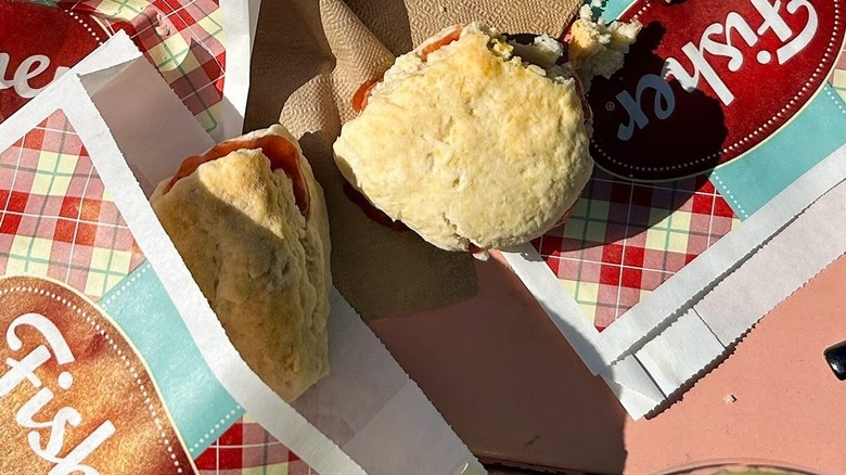 Fresh Fisher Fair Scones, filled with raspberry jam, one in a bag and one out of the bag.