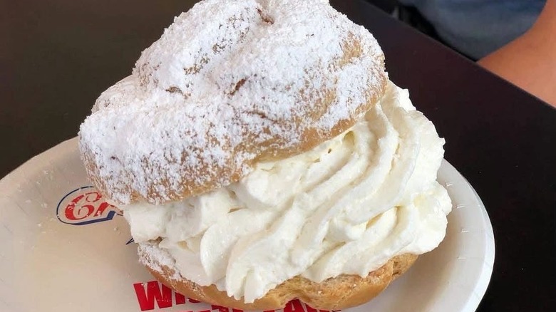 A Wisconsin State Fair cream puff, filled with whipped cream and dusted with powdered sugar.
