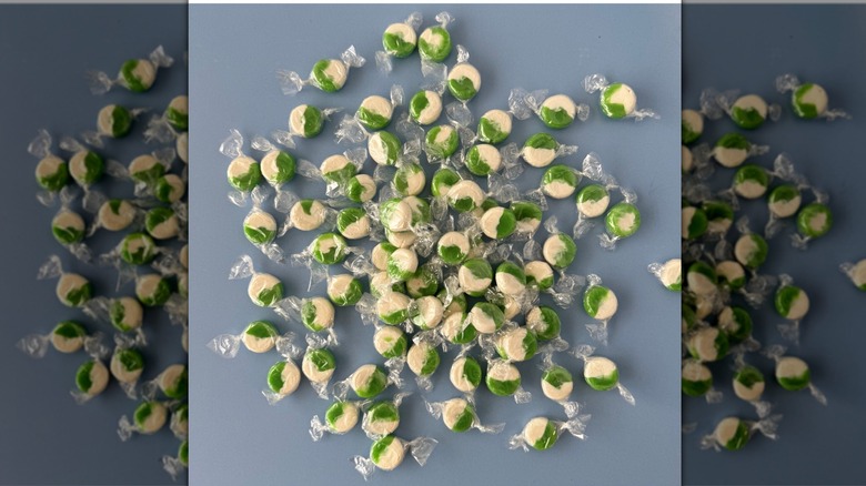 Kermit's Key Lime Shop's Key Lime Candy green and white individually wrapped and scattered on blue background