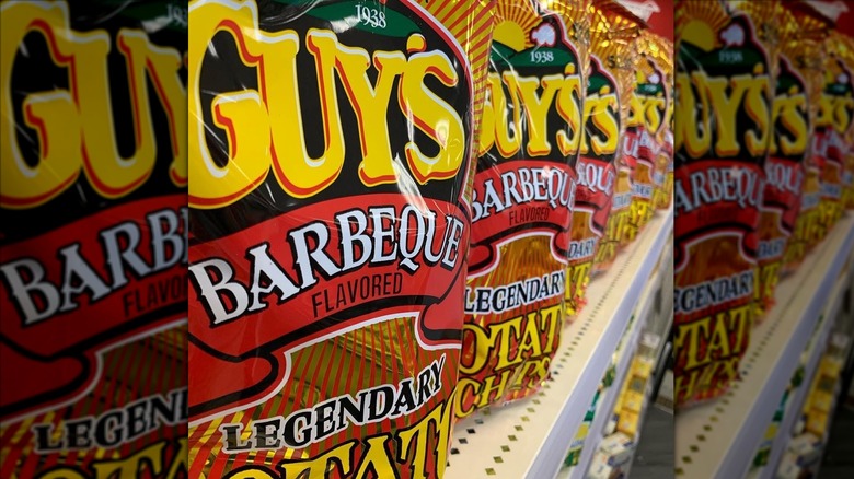 Close-up of  a row of Guy's Barbecue Chips on grocery store shelf