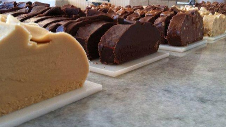 Trays of various sliced Mackinac Island Fudge on a bakery counter