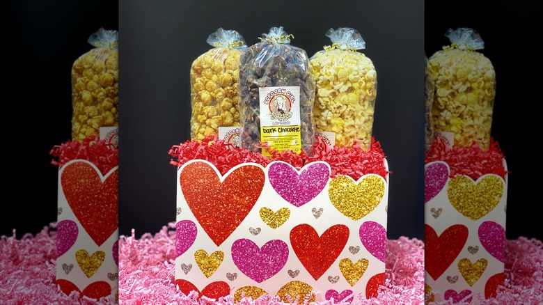 Assorted Popcorn Girl Brand popcorn for Valentine's Day with glitter hearts on stand