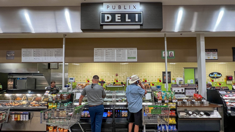 Two men waiting at the Publix grocery store deli counter