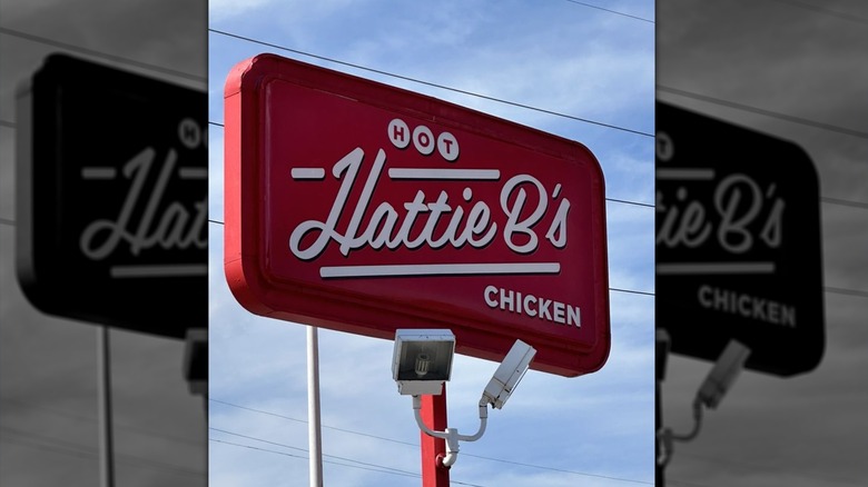 The exterior Hattie B's sign: Hattie B's is written in white on a red background with "hot" above it and "chicken" below it