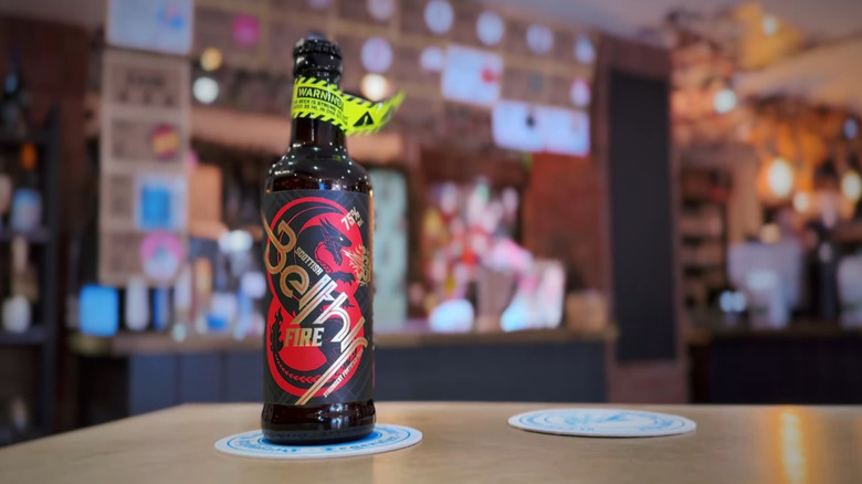 A bottle of Scottish Beithir Fire with the warning label around the neck