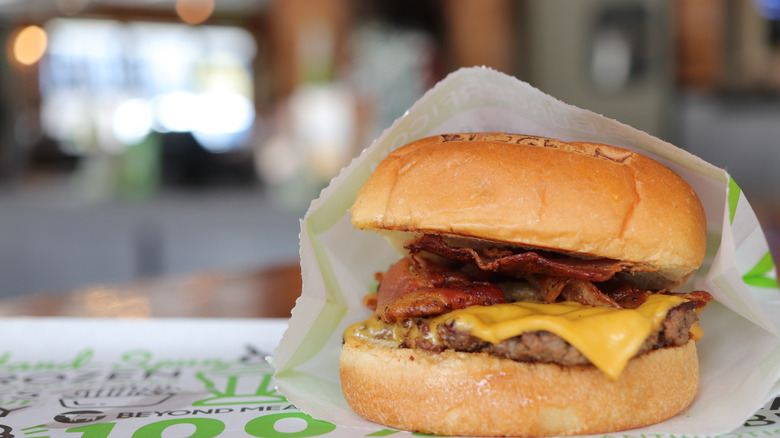 BurgerFi burger in paper sleeve